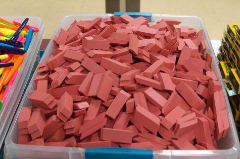 A tub of large pink erasers.