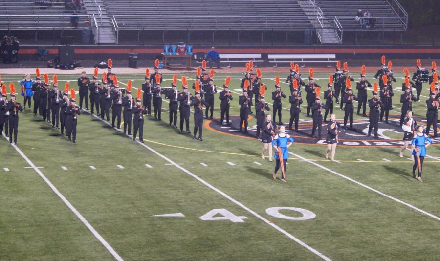 The band performs at the last football game of the season. The band finished their season with a variety of awards. 