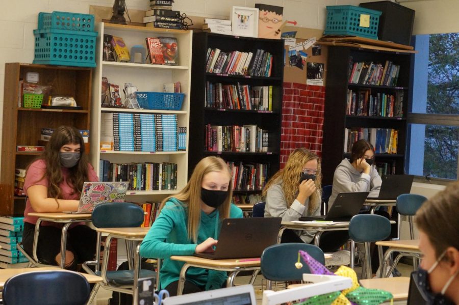 Students working in class, wearing masks