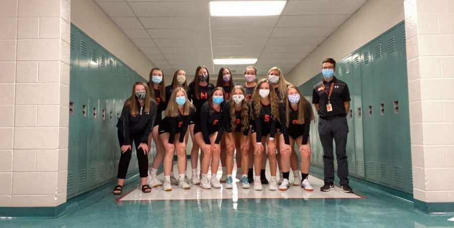 Varsity volleyball team with masks