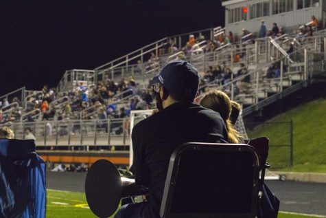 Marching Band member watching the game ready to play.