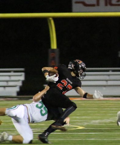 Dublin Scioto player attempting to tackle number 27.