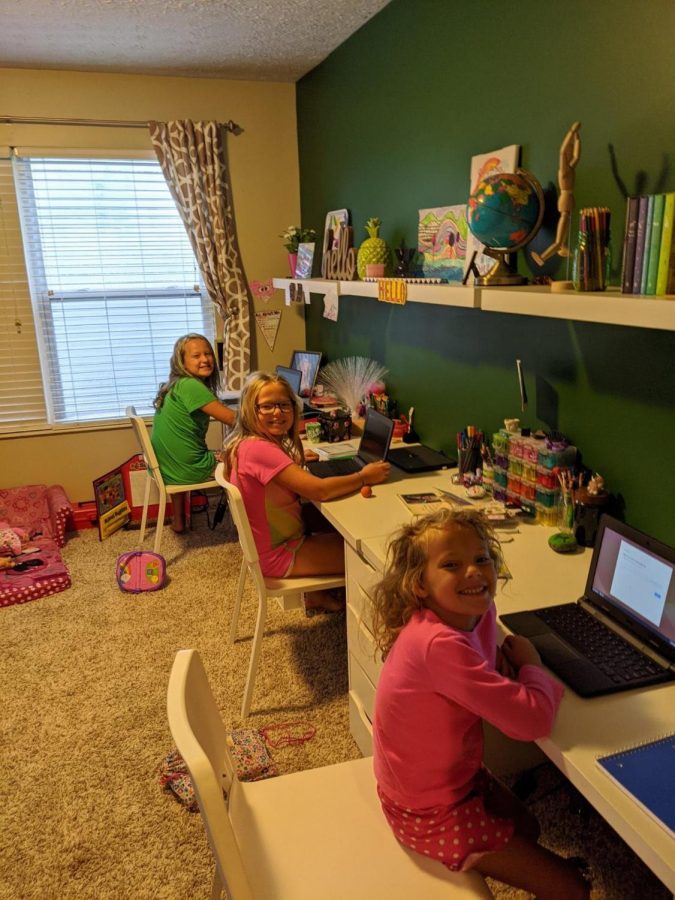 Members of the Luce family show off their online learning environment.  Having to balance supervising the education of kids with a full time job has made life much more challenging for many working-from-home mothers.
