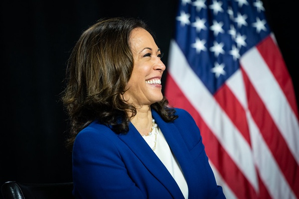 Kamala Harris stands in front of an American flag