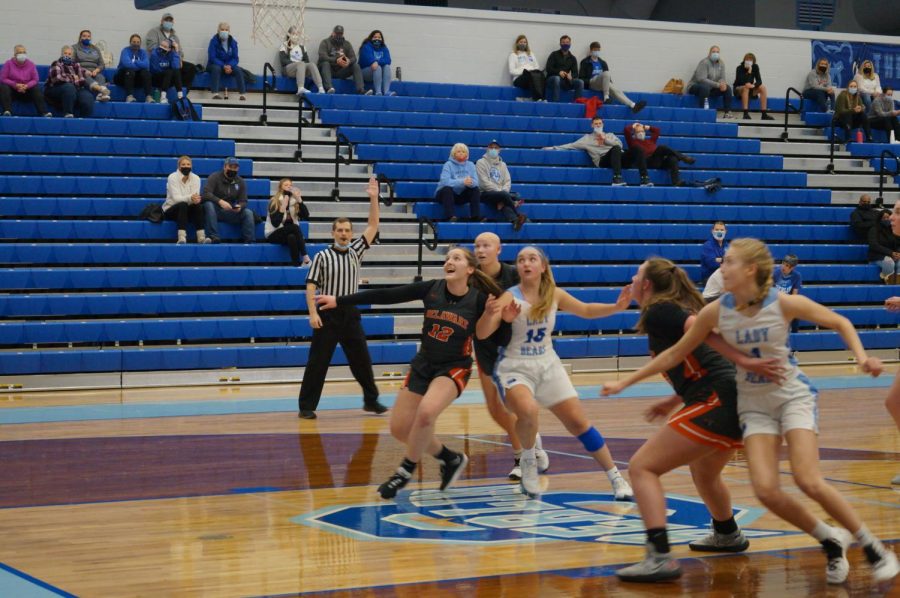 Hayes basketball players box out a shot.