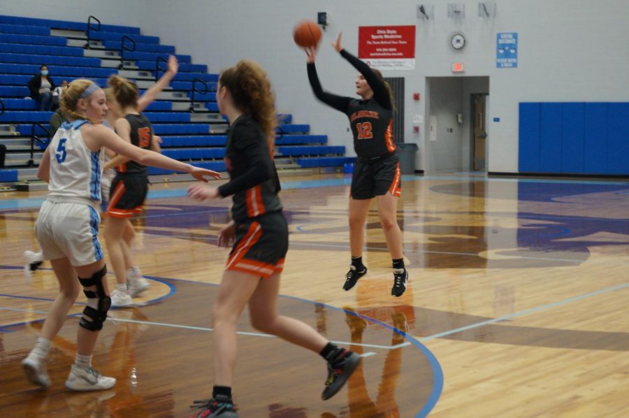 Hayes basketball player shoots a three point shot.