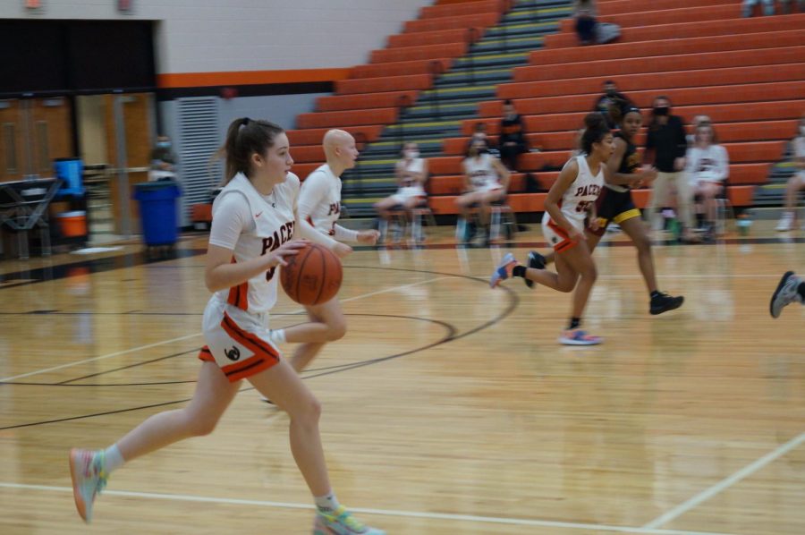 Lady Pacer hustles down the court.