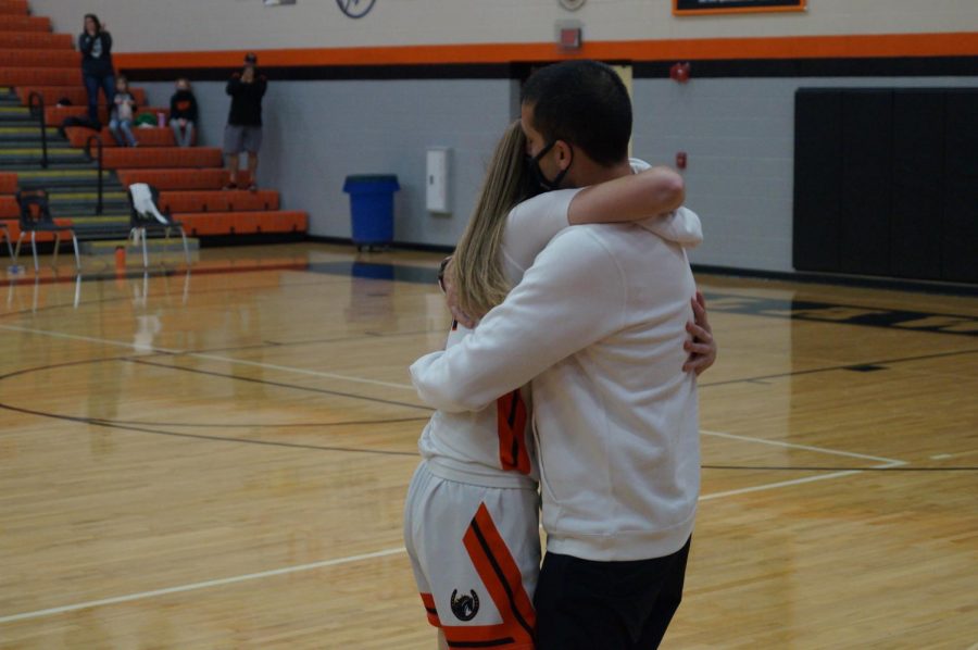 Lady Pacer hugs her dad after scoring 1000th point.