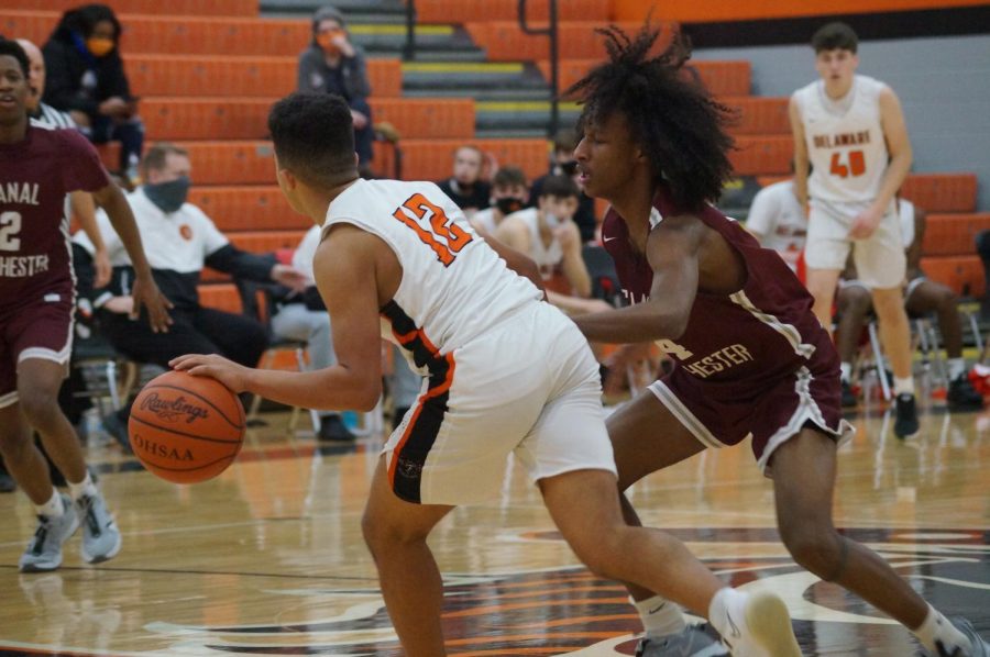 Hayes basketball player dribbles ball.