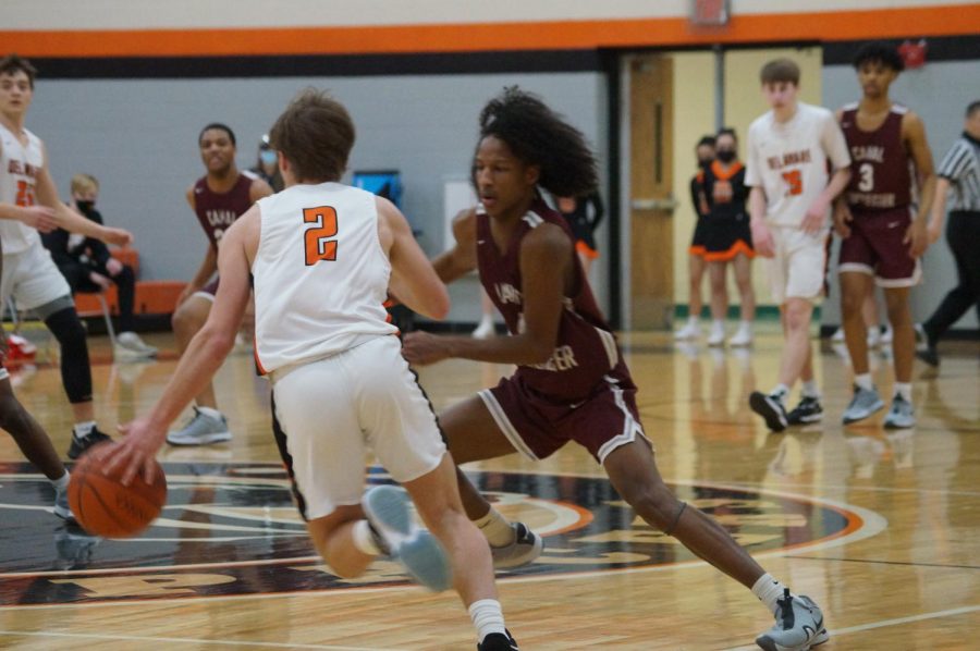 Hayes basketball player takes the ball up the court.