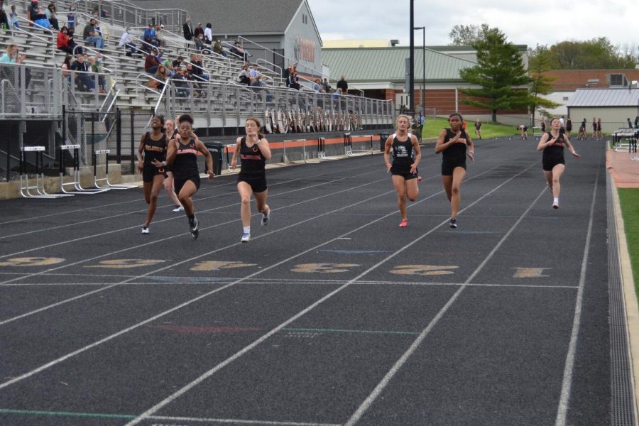 Runners in 100 meter dash near the finish line.