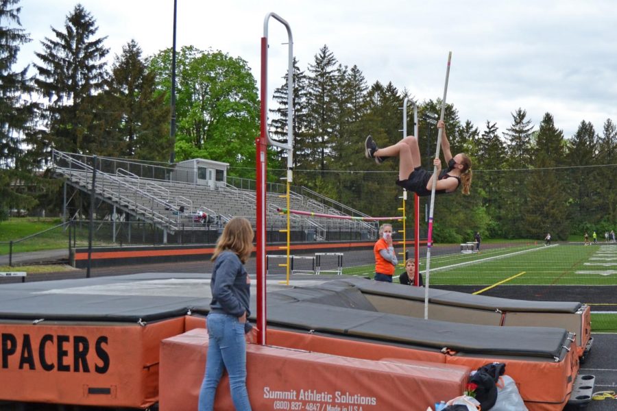 Senior Rebecca Young prepares to clear bar.