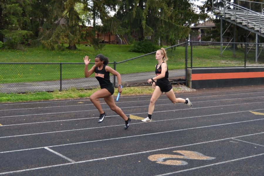 Hannah Halstead completes baton handoff to Taylor Brown in 4x200 relay.