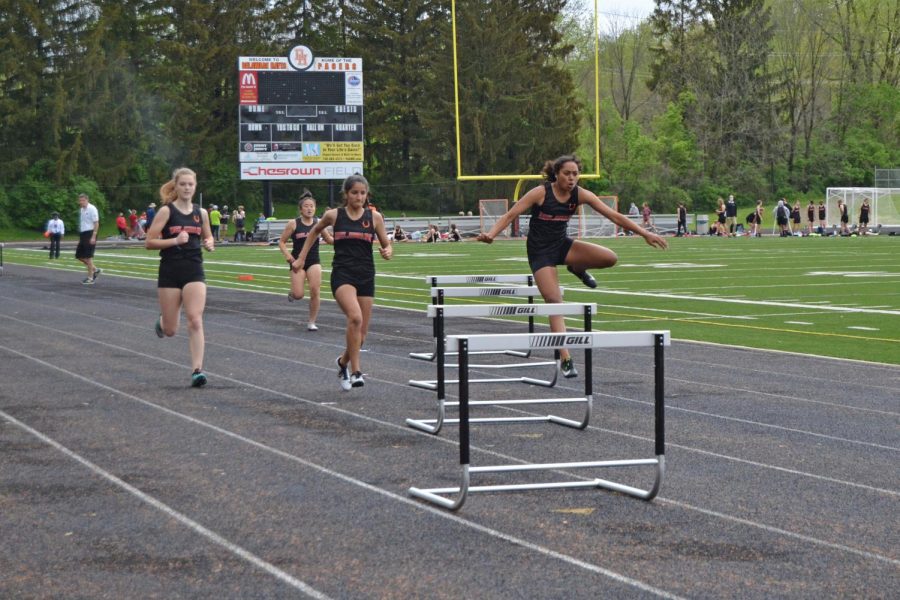 Sophomore Olivia Dean clears hurdle while in the lead for the 300 meter hurdles.