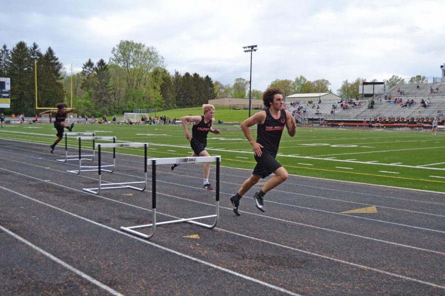 Tyler Zembo leads in the 300 meter hurdles, Will Polter and Caleb Forney follow close.