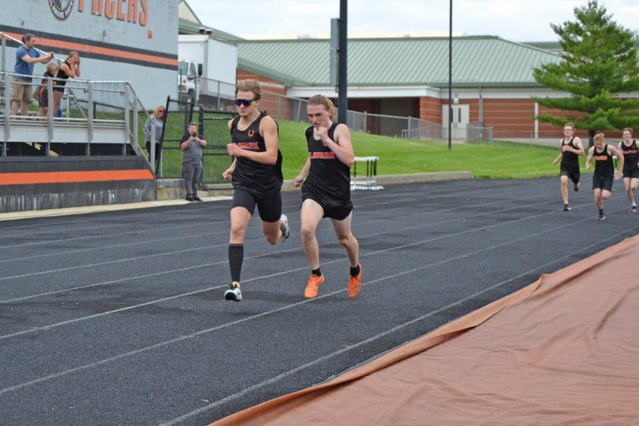 Senior Owen Salyers pushes to pass Padraig Mumper at end of 800 meter dash.