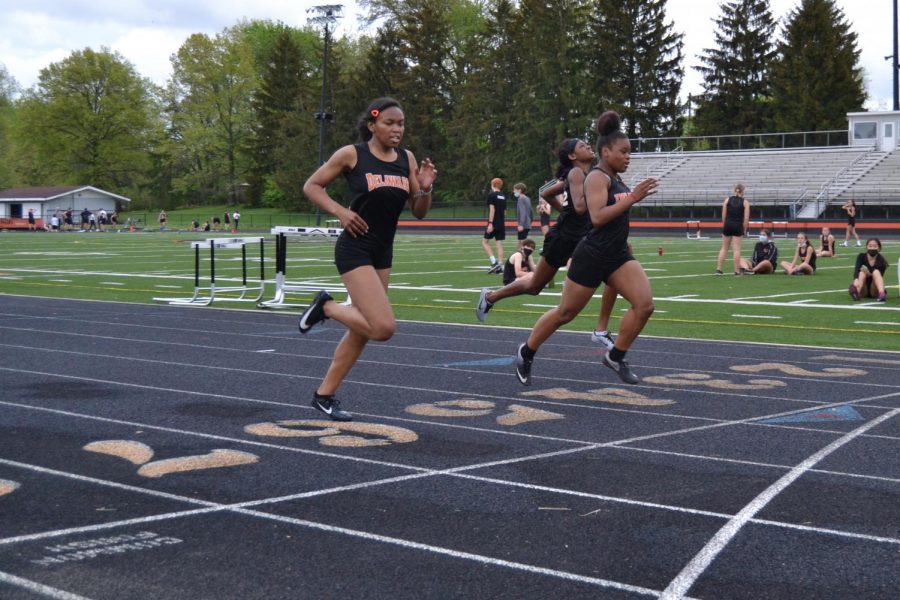 Runners finish 200 meter dash.