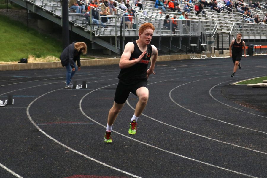 Senior Josh Koeler turns the first corner in the 400 meter dash.