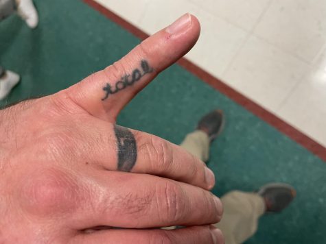 History teacher David Morgan has two finger tattoos representing his marriage.