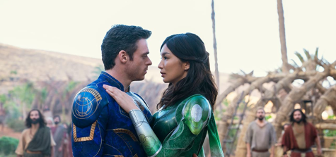 Sersi (Gemma Chan) and Ikaris (Richard Madden) share an embrace in Marvels Eternals. The film is now in theaters everywhere.