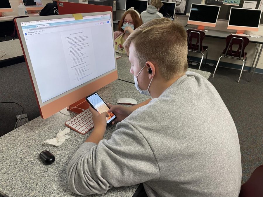 A student browses their phone during class. The use of devices in class has become an epidemic of sorts in Hayes.