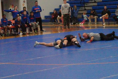 Junior Kasey Wells pins opponent during the first period of her match.