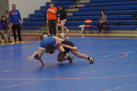 Junior Kelcey Dew tackles opponent in order to get her on the mat.