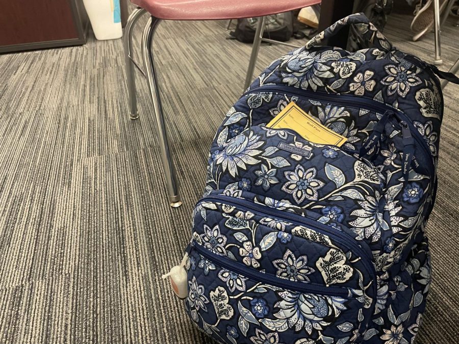 A+backpack+sits+a+classroom+with+a+yellow+hall+pass+on+top+of+it.+The+yellow+passes+are+one+of+many+changes+being+instituted+at+Hayes+to+solve+disciplinary+issues.