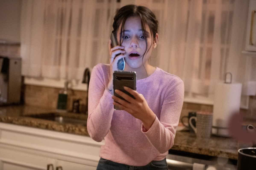 Tara (Jenna Ortega) reacts in horror as she receives a phone call from serial killer Ghostface in Scream (2022). The film is now playing in theaters.