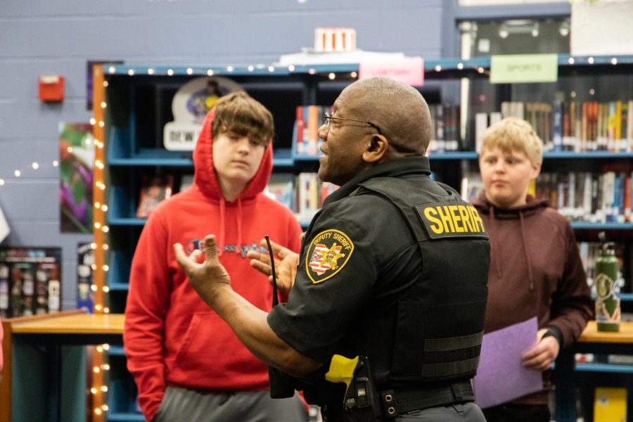 Officer answers students questions during Cocoa with a Cop