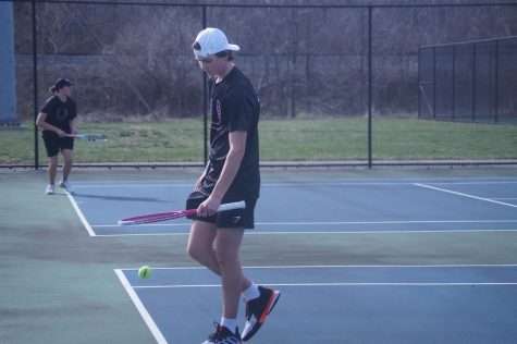 Junior Gabe Fogle plays in a tennis match against River Valley this spring.  Fogle was the first member of the team to qualify for the District tournament since 2019.