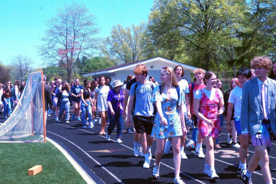 Seniors take a look out to the stands as they walk the track.