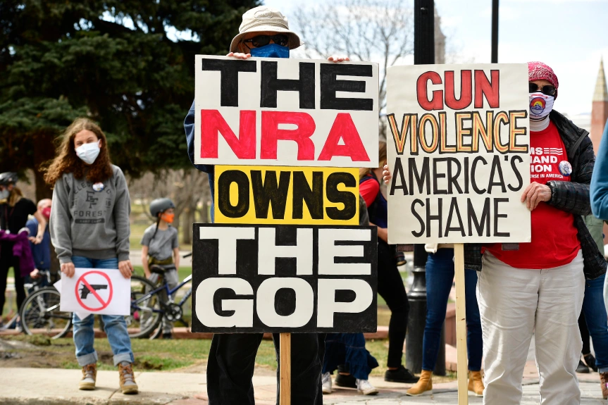 Gun+violence+protesters+stand+on+the+steps+of+the+Colorado+State+Capitol+on+March+28+brandishing+signs.+The+protests+come+after+repeated+acts+of+mass+violence+using+firearms.