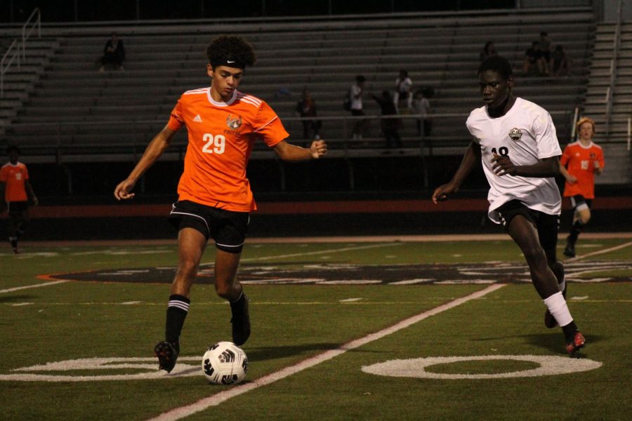 Junior Samuel Junior Rosa works around a defender during the Sept 9 soccer game.