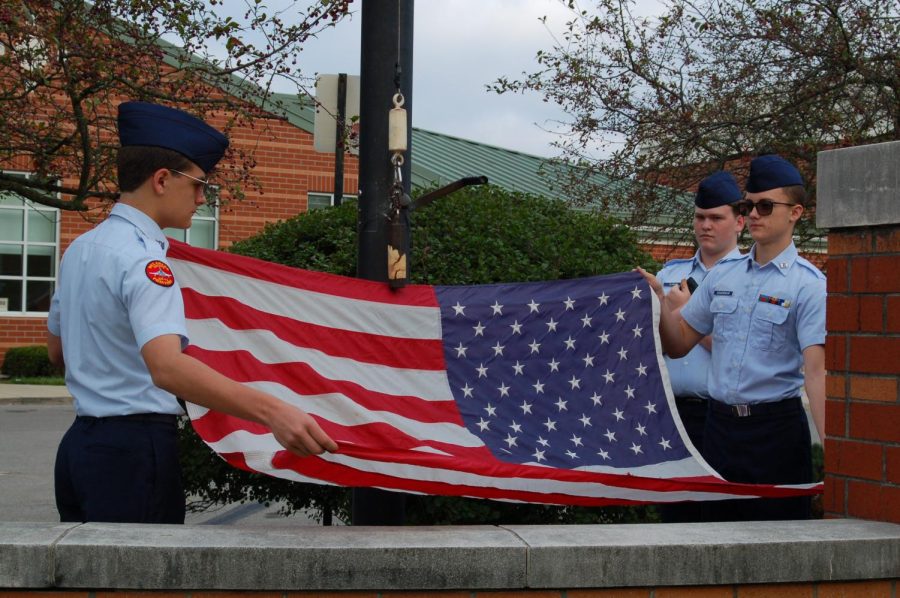 Cadets put up the American flag. 