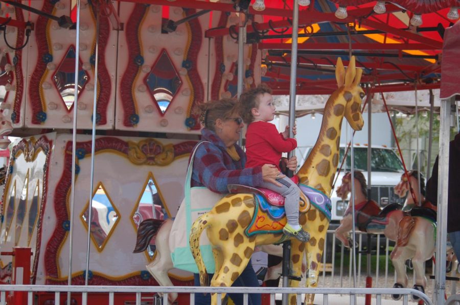 A grandmother and her grandson ride on the Carousel at the Delaware County Fair. 