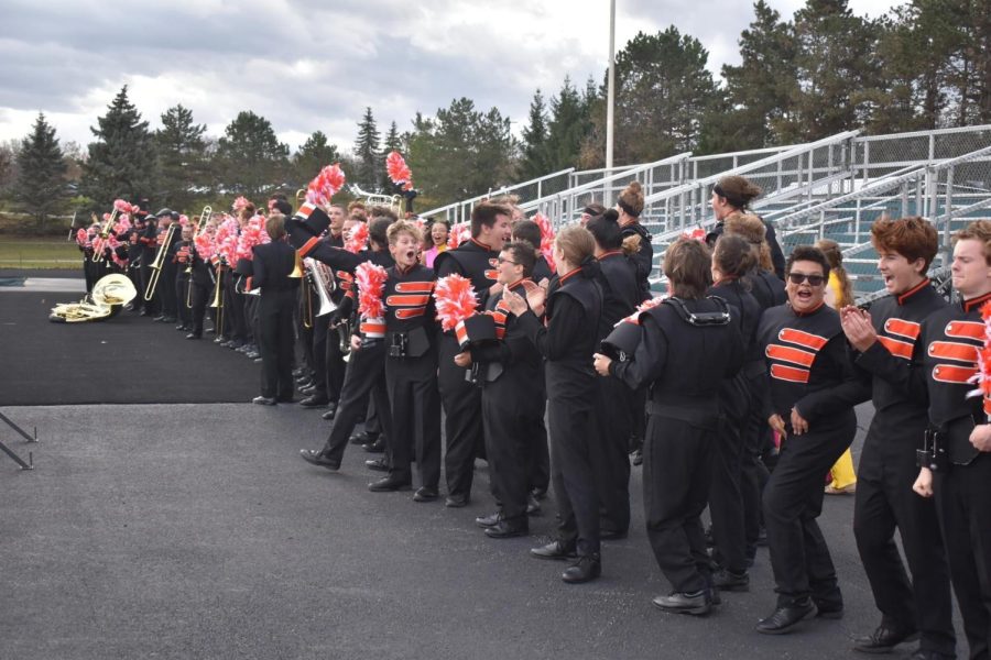 Members of the marching band celebrate after hearing that they received a Superior rating at State Finals.