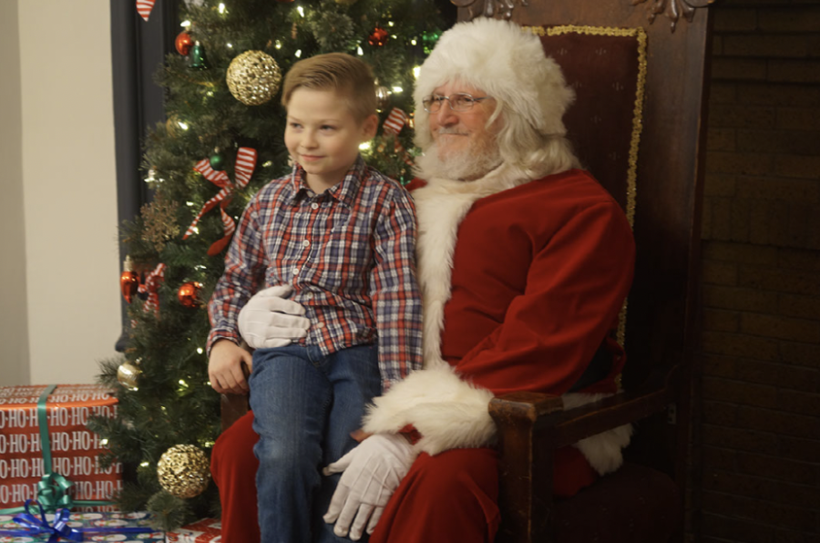 A child and Santa take a photo together during the downtown Delaware Christmas event.