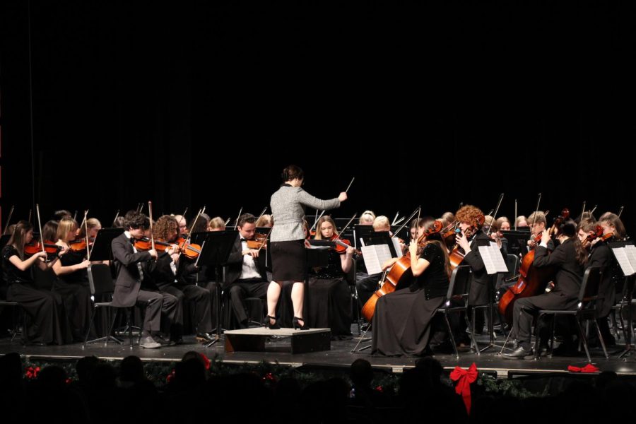 Orchestra director Keegan Lammers conducts the orchestra. 