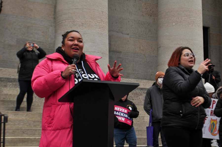 The president and CEO of Planned Parenthood Southwest Ohio, Kersha Deibel, addresses the crowd while a sign language interpreter signs next to her.