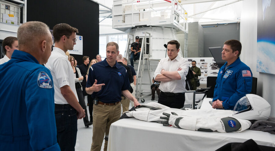 SpaceX Chief Engineer Elon Musk, and others from SpaceX and NASA look at a version of a SpaceX spacesuit in Hawthorne, CA.