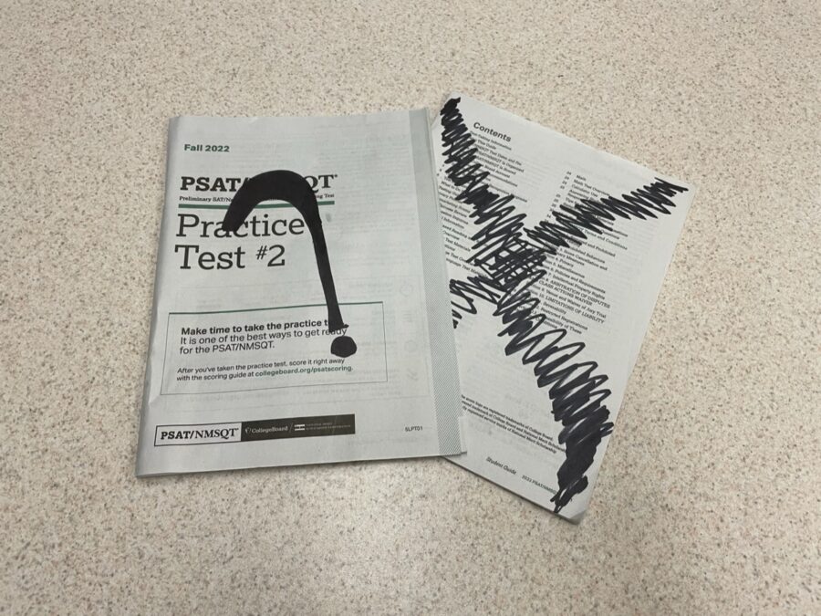 A PSAT practice test packet sits on a desk. The legitimacy of the SAT test has been called into question in recent years due to its rocky past.