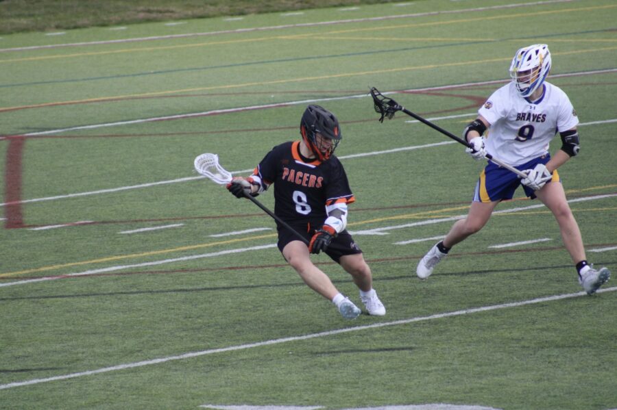 Cooper Heald cradles the ball during the March 25 lacrosse game against Olentangy High School.