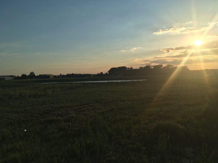 The sun sets over a field in Delaware, one hour later than before due to daylight saving.
