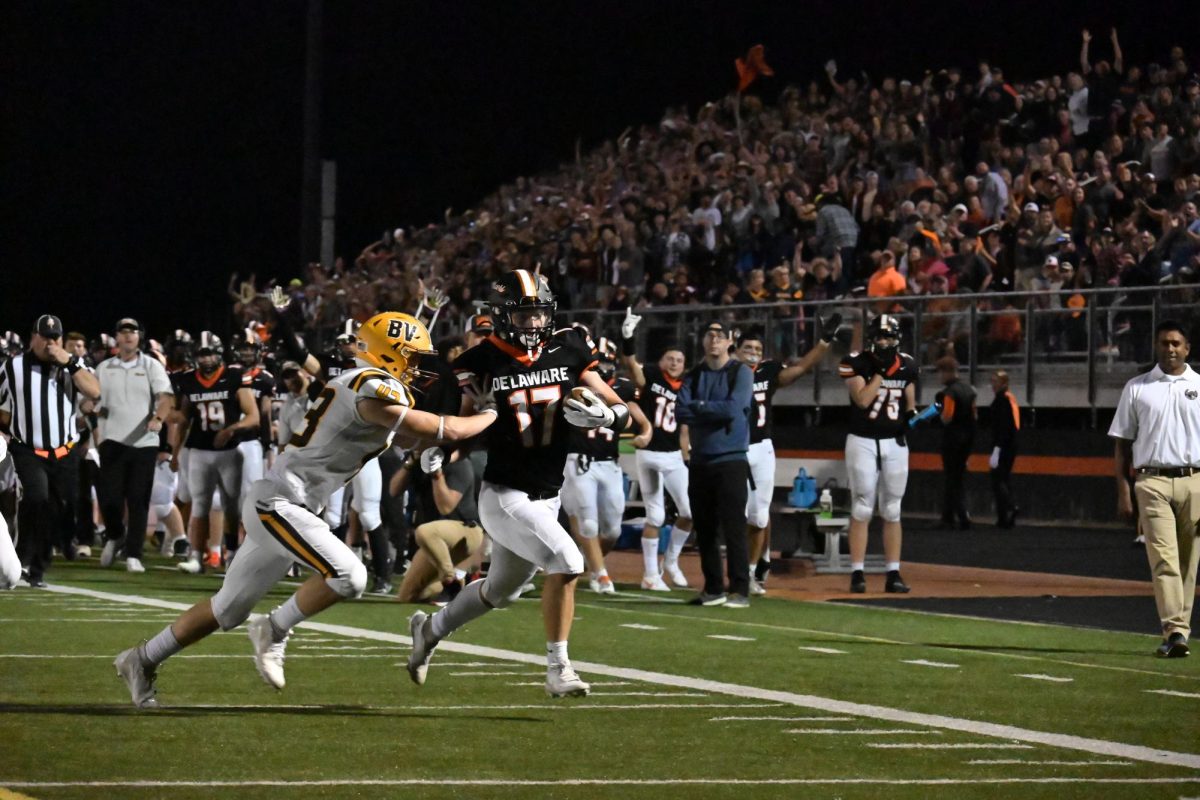 Cooper Goble tries to shed a tackle as he makes his way to the end zone.