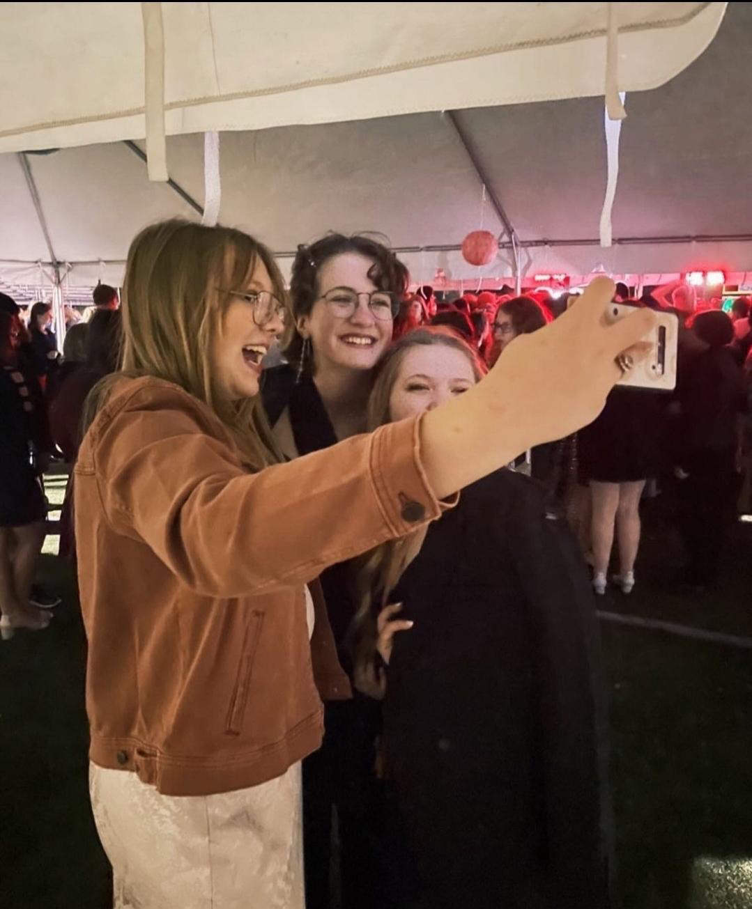 Samantha Myers, Emily Ward and Brynna Pauley smile together for a selfie at last year’s homecoming dance.