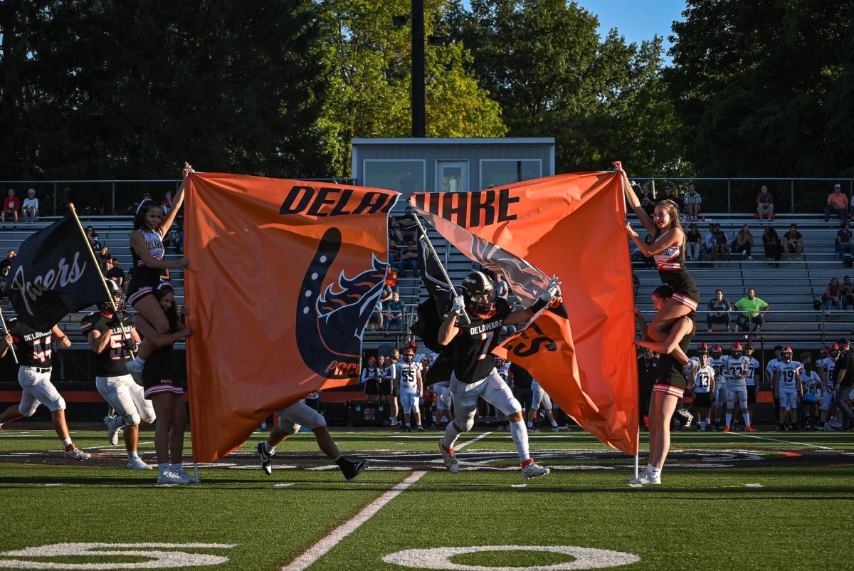 Koslow leads the team out of the locker room through the banner.
