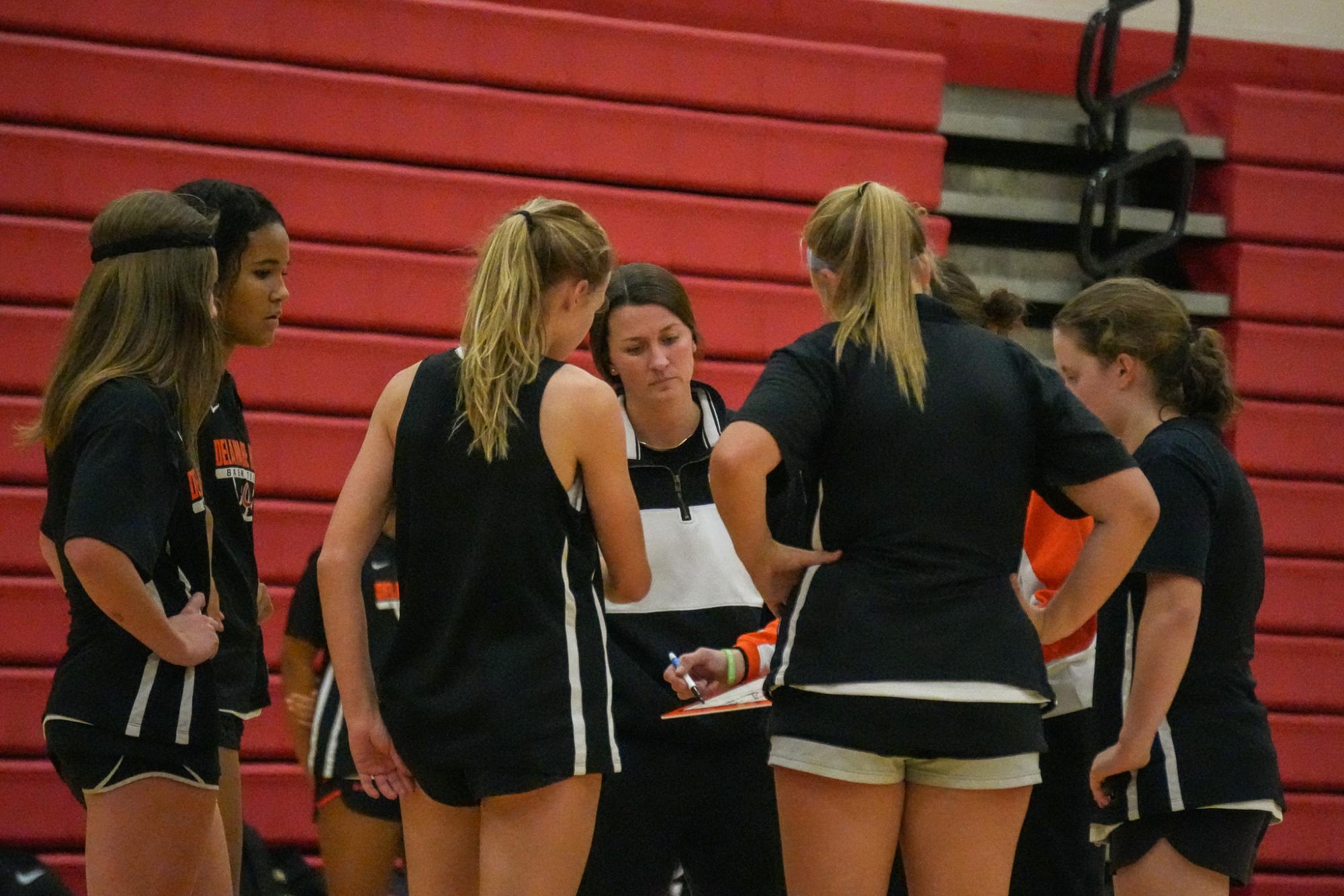 The Lady Pacers huddle together in-between quarters. 