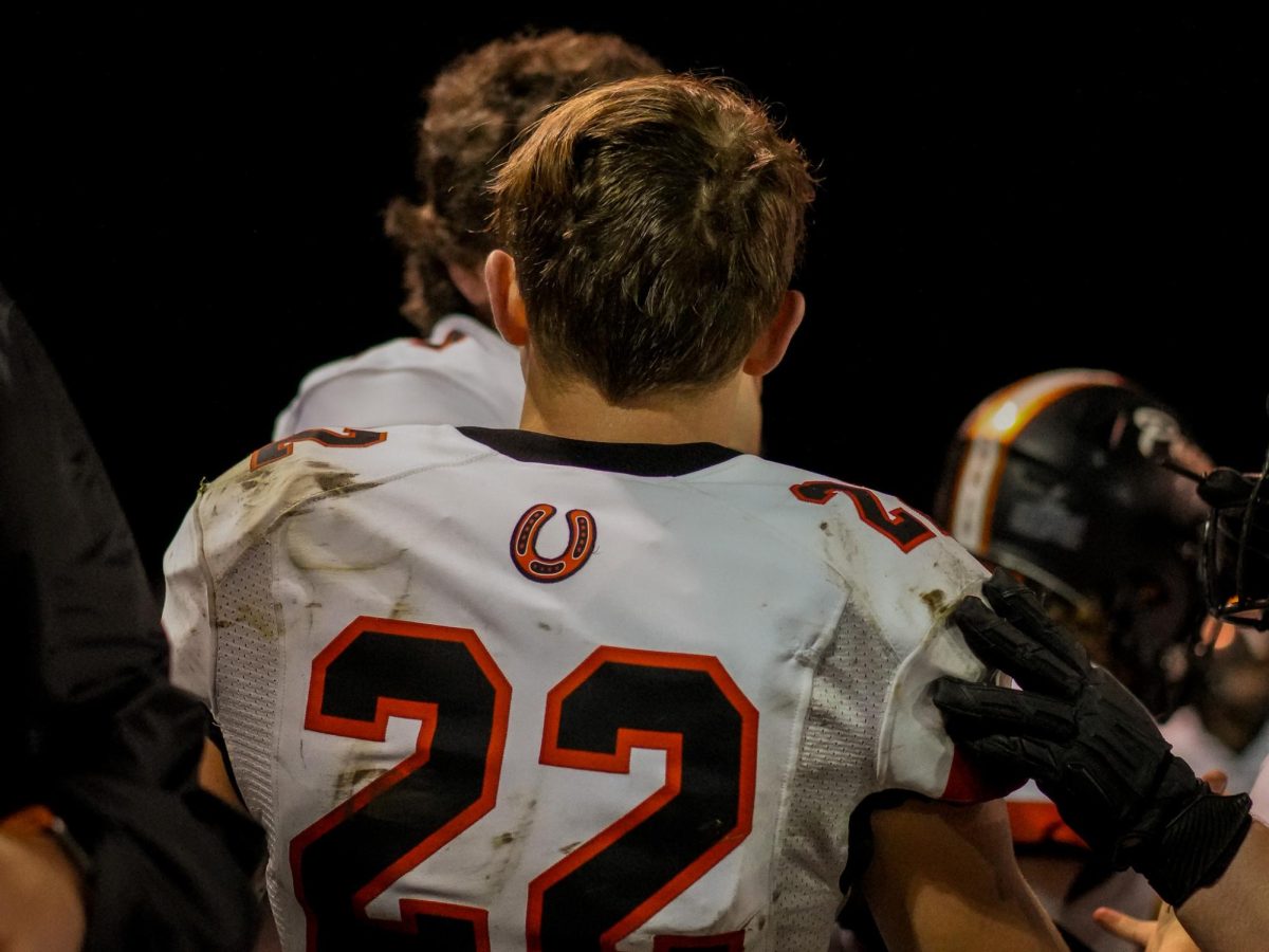Junior Garrett Brown talks with his teammates on the sideline. 