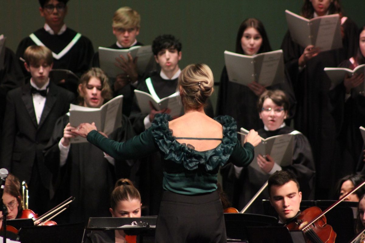 Choral Director, Dr. Dara Gillis, controls the combined groups through their multiple pieces.